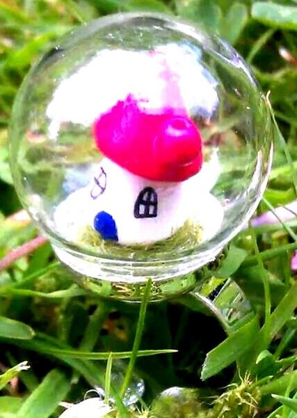 Fairy house globe ring atop faux grass